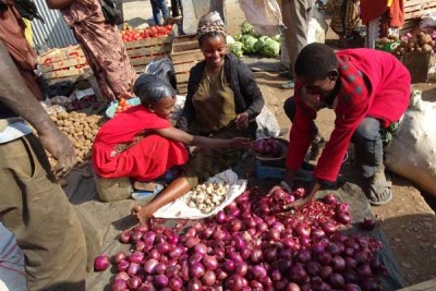 Meres Abe, an Ethiopian businesswoman and her children sells at the Moyale open air market.