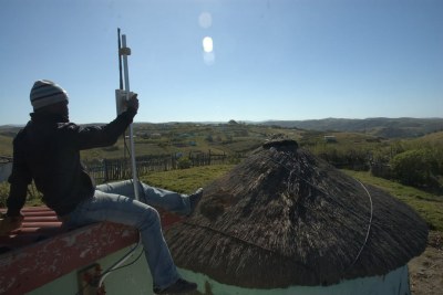 A Zenzeleni cooperative member carefully aligns some equipment in the village of Mankosi, Eastern Cape.