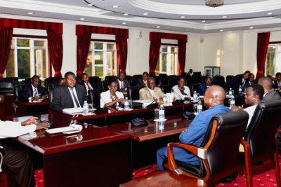 President Yoweri Museveni, left, in discussion with the parliament’s legal affairs committee led by Oboth Oboth, second left.
