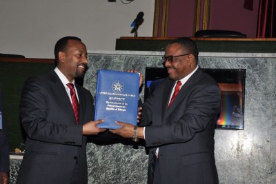 Hailemariam handing over the constitution to the incoming Premier