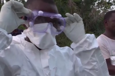 A health worker dons protective clothing (file photo).