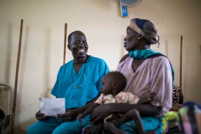 South Sudanese surgeon, Evan Atar Adaha, 52, and winner of the Nansen Refugee Award, sits with a refugee from Sudan and her malnourished son in the nutrition stabilization centre of Maban Hospital in the town of Bunj, Maban County, South Sudan on May 8, 2018.