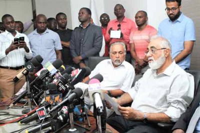 Gullam Dewji. left, father of missing Mo Dewji, is flanked by relative Azim Dewji during a press briefing in Dar es Salaam.