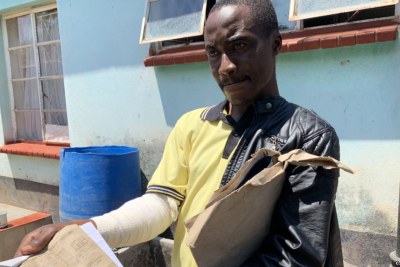 Adrian Munjere, who sustained fractures on his right hand during post-election clashes between security forces and protesters Aug. 1, displays his doctor’s report.