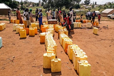 People line up at a borehole at Kiryandongo refugee settlement camp during a water crisis that hit the region in November last year.