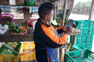 Ann Waithera orders new produce through the Twiga mobile app for her general store on the outskirts of Nairobi.