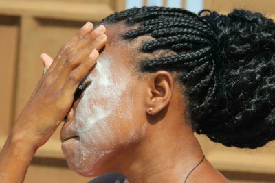 A woman applies a bleaching soap on her face with the hope of lightening her complexion (file photo).
