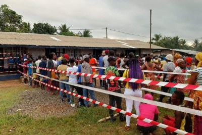 Voters line up outside a polling station for the second round of the presidential election in Monrovia, Liberia - November 14, 2023